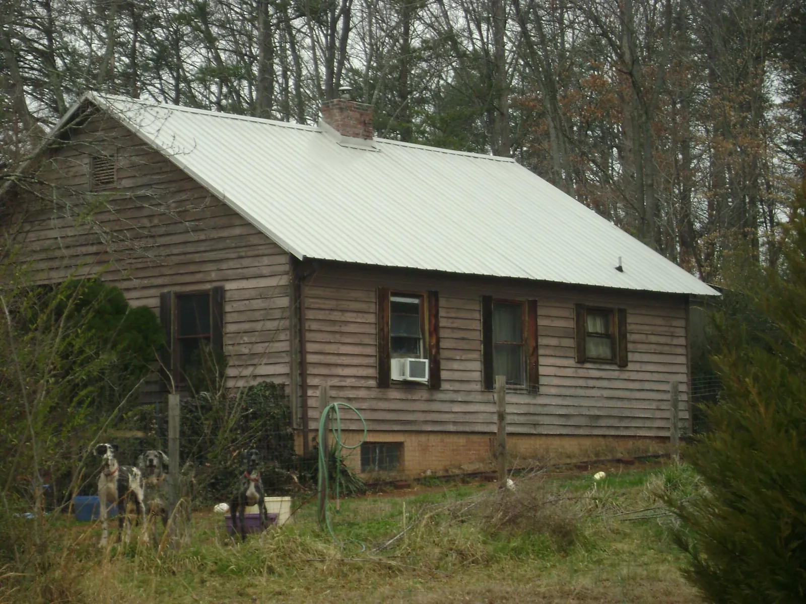 White metal roof on an old wood sided farmhouse, from a Metal Roof Installation job in Huntingdon